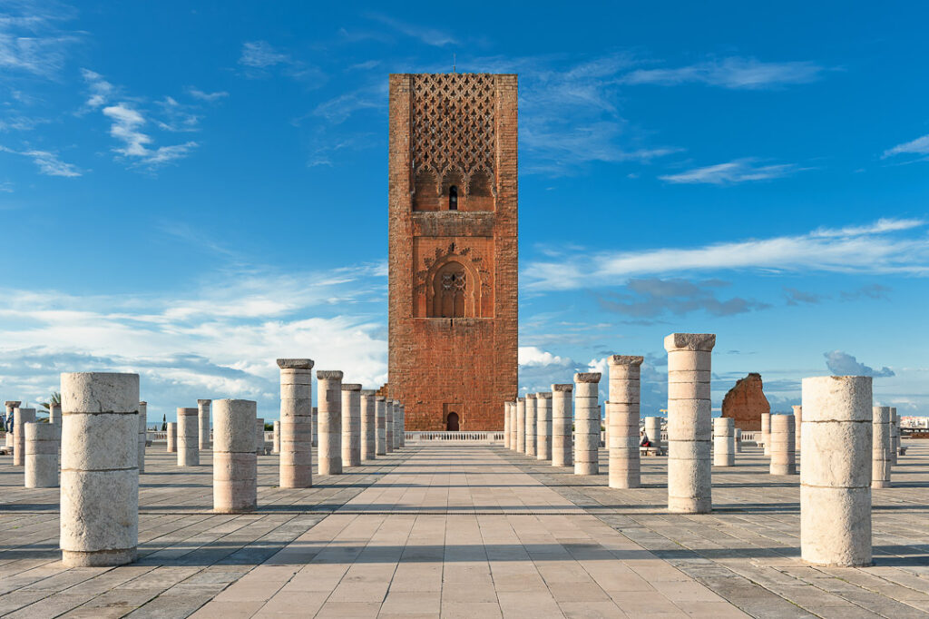 Tour Hassan tower in the square with stone columns. Made of red sandstone, important historical and tourist complex in Rabat, Morocco. Instead of stairs, the tower is ascended by ramps.